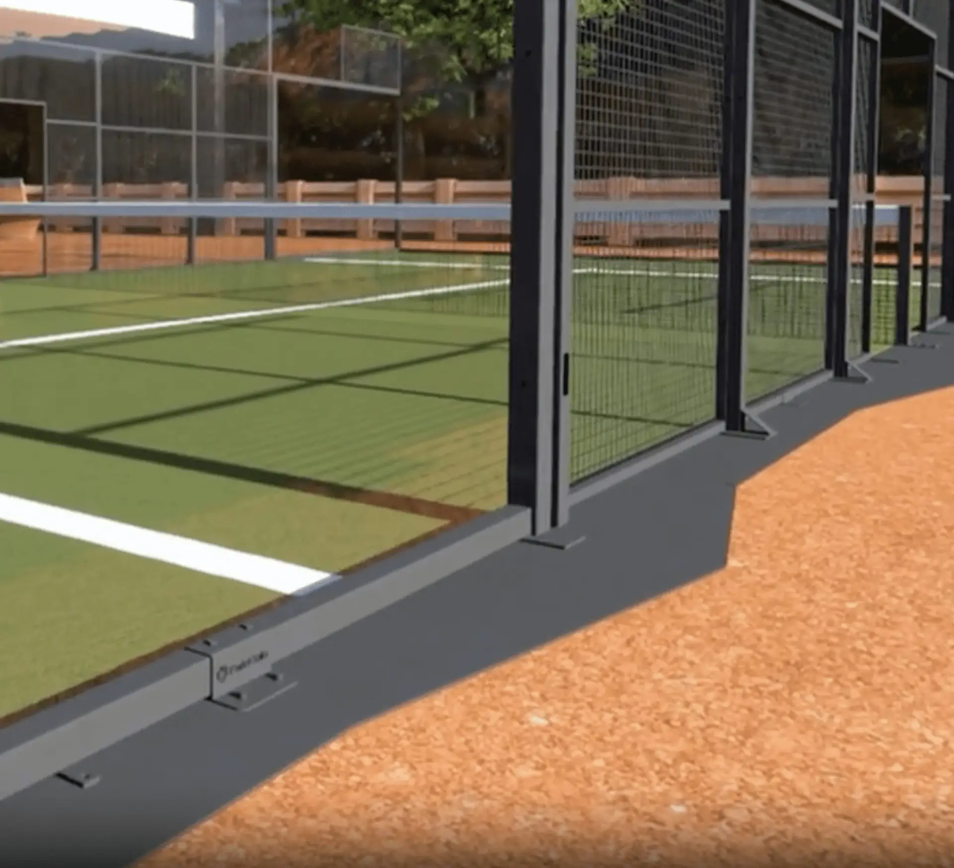 Close-up view of a padel court construction showing the court surface and surrounding fencing.