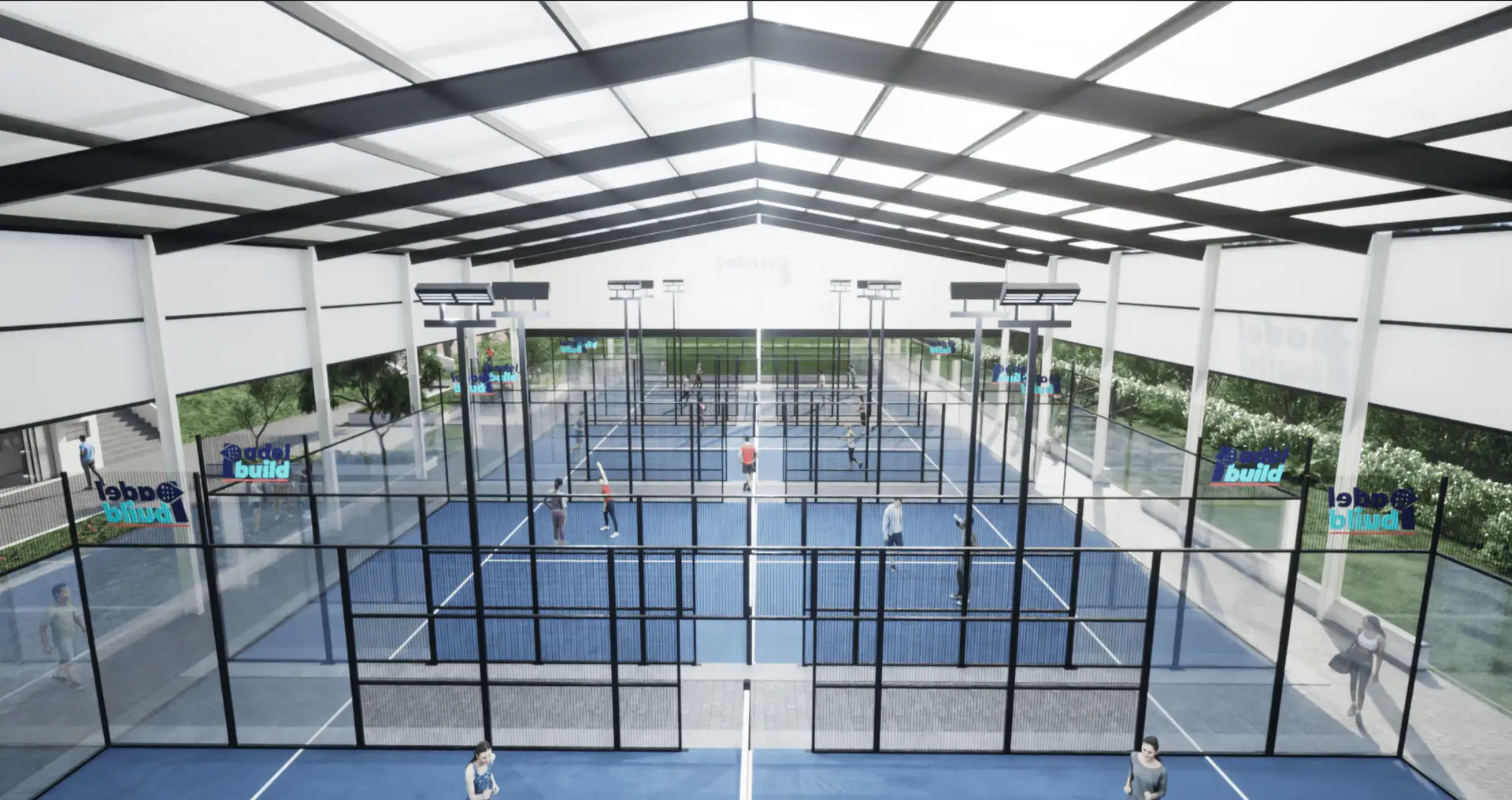 View of indoor padel tennis courts with players in action and glass walls.