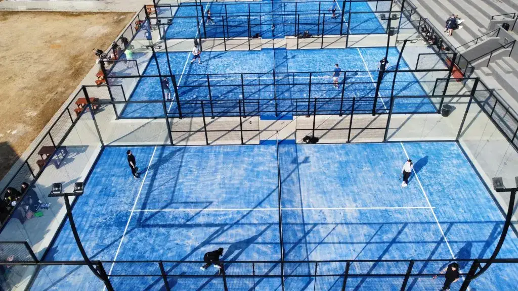 Aerial view of multiple outdoor padel courts with players engaged in matches