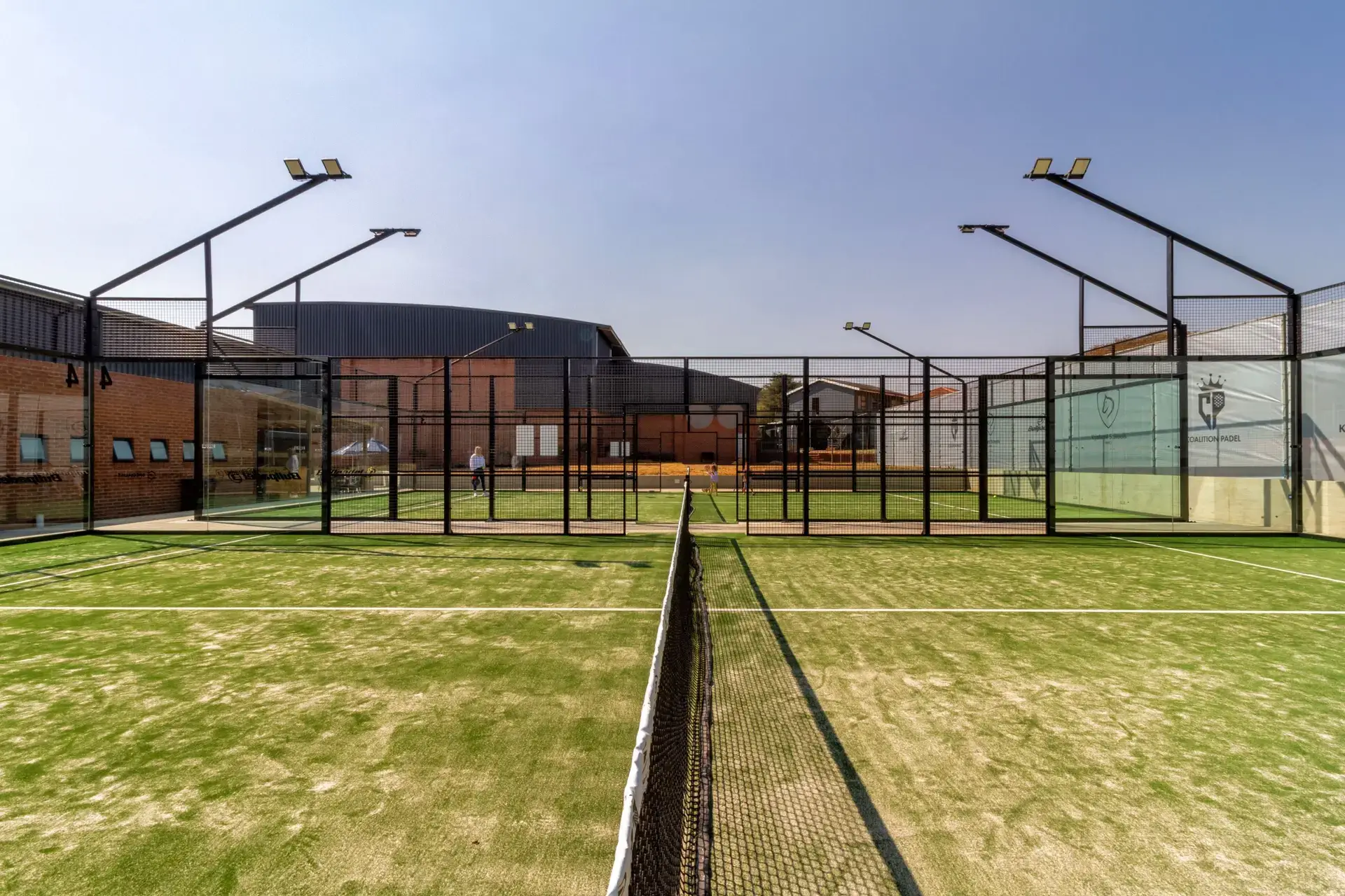 Outdoor Padel Build court with Mundial 90 configuration, green turf, black mesh fencing and floodlights at a private school in South Africa.